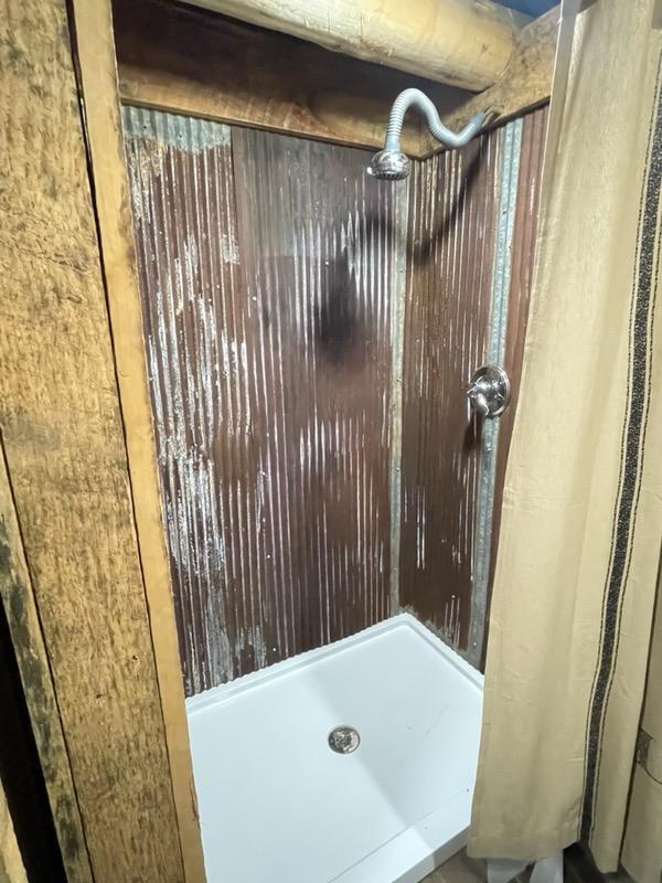 Rustic stand-up shower.